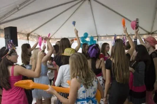 Guests dancing under a tent at a party