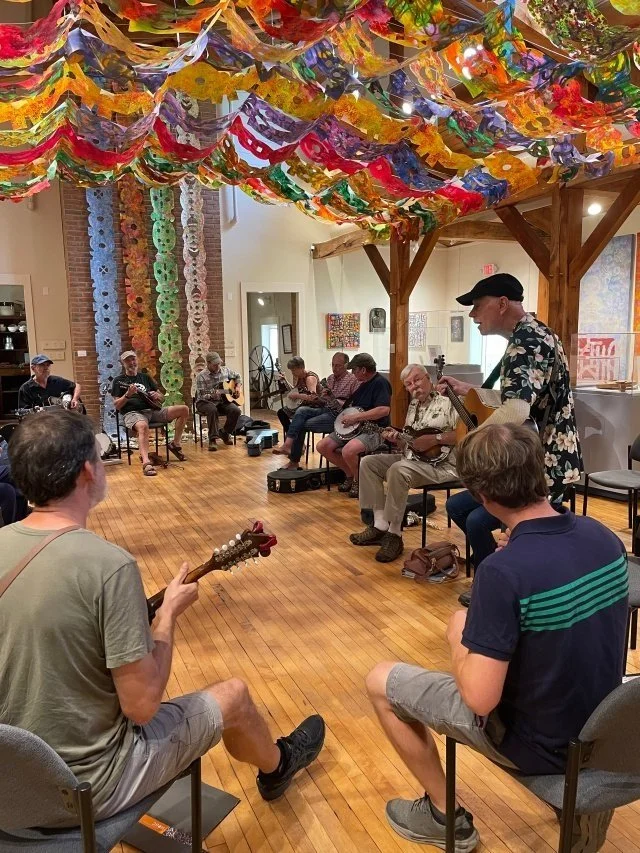 Musicians playing guitars and banjos together