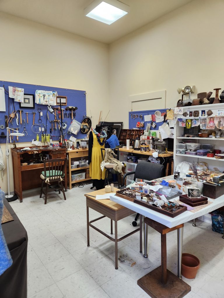 Artist studio with work tables and artwork