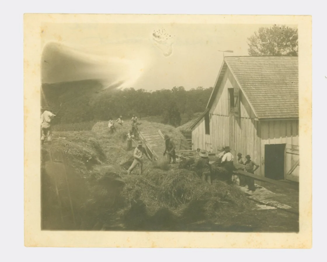 People gathered beside a farm building