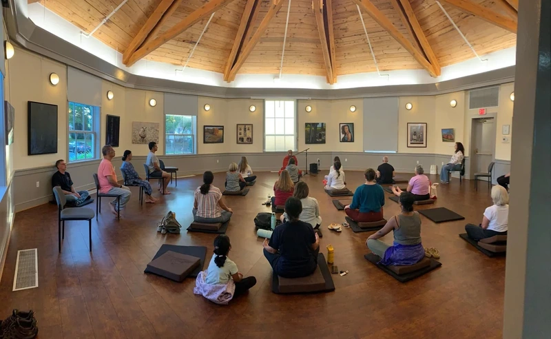 Group meditation session in a round room at Sandy Spring Museum