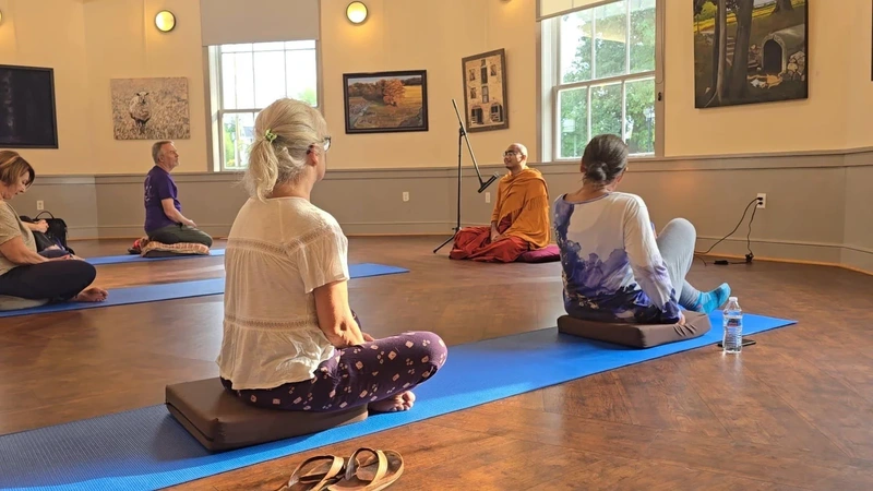 Visitors meditating with a Buddhist monk at Sandy Spring Museum