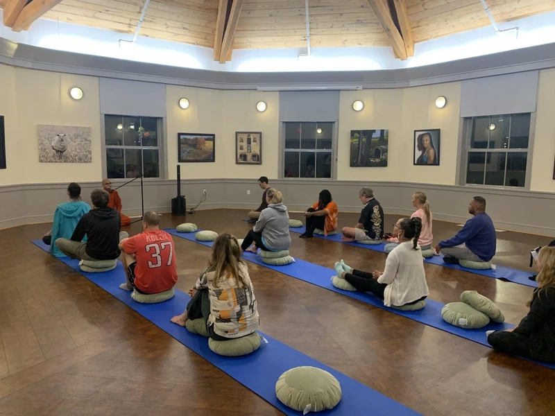 Participants seated on cushions during a guided meditation session