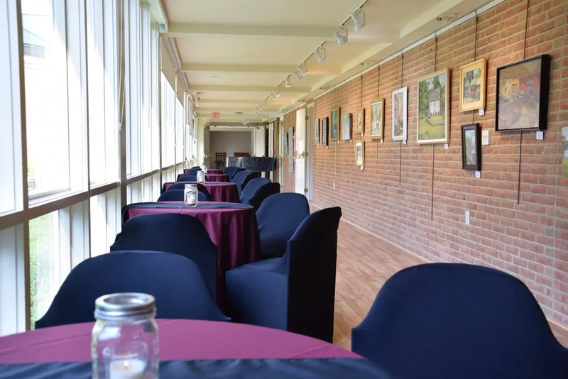 Museum gallery arranged with tables for an event