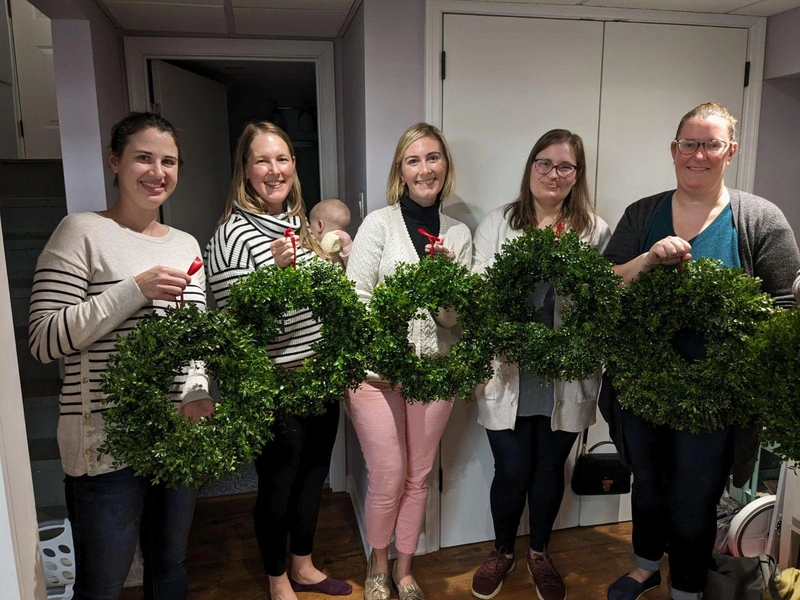 Garden Club workshop participants holding their handmade wreaths