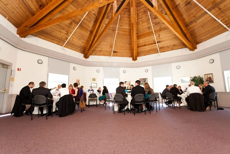 Guests seated at tables in a museum event hall