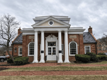 A brick bank building with a white columned entrance.